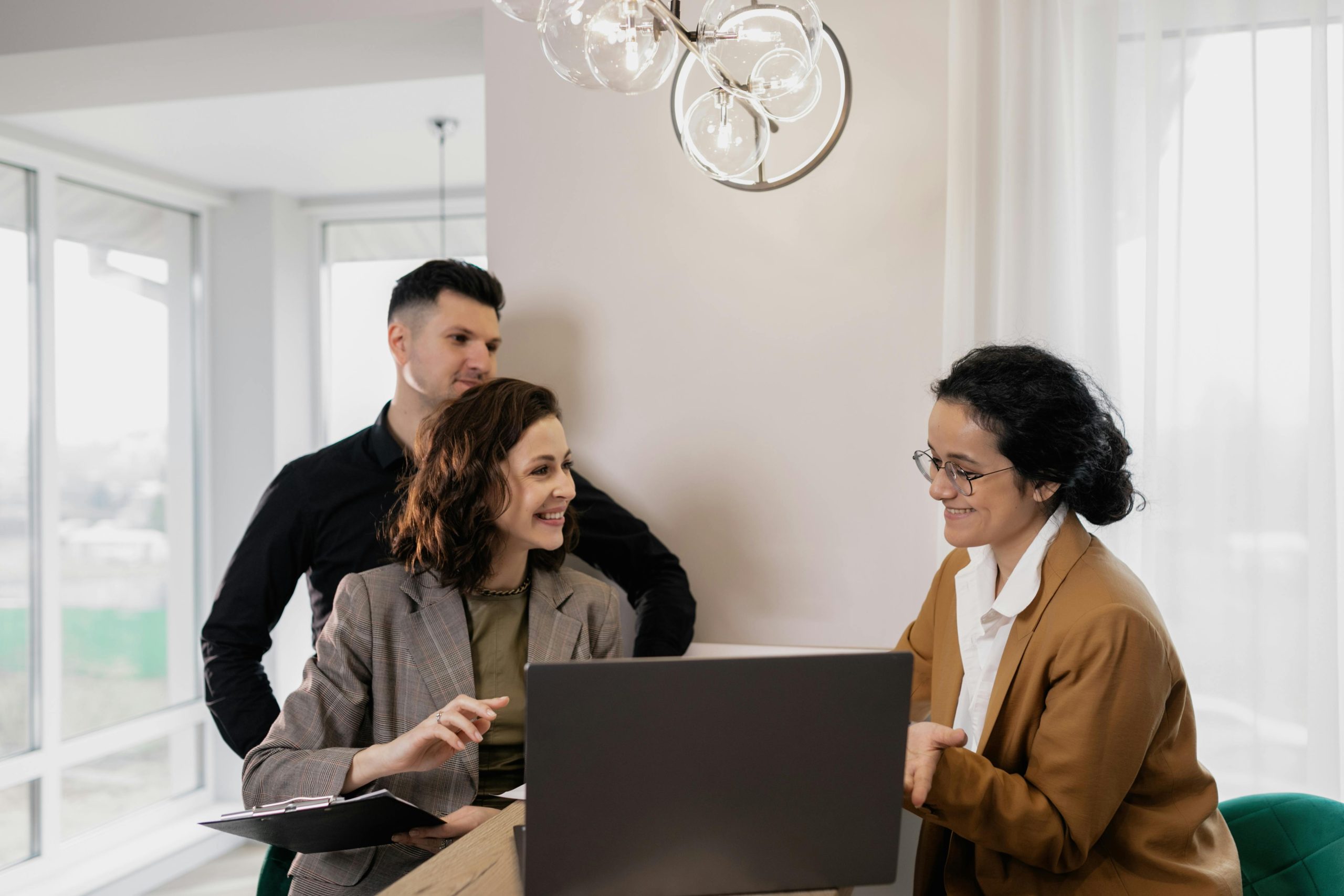 homeowners-to-be sitting at a desk, negotiating house price with seller